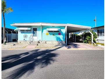 Charming, well-maintained mobile home featuring a covered carport and tasteful decor, perfect for coastal living at 34483 Cactus N Dr, Pinellas Park, FL 33781