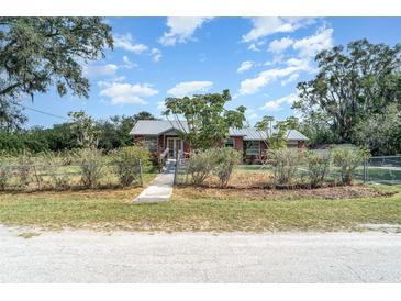 Charming single-story home with a metal roof and well-maintained front yard at 6118 Kracker Ave, Gibsonton, FL 33534