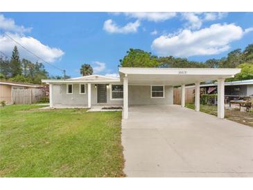 Charming single-story home with a well-maintained lawn and covered parking at 6612 W Chelsea St, Tampa, FL 33634