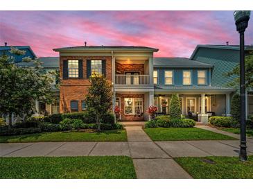 Charming two-story townhome with brick facade, balcony and lush landscaping at 10035 New Parke Rd, Tampa, FL 33626