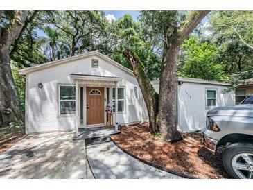 Charming single-story home with mature trees, a walkway, and a nicely landscaped yard at 1608 E Linden Ave, Tampa, FL 33604