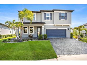Beautiful two-story home with a well-maintained lawn and a paved driveway leading to a two-car garage at 34307 Radley Way, Wesley Chapel, FL 33545
