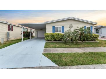 Charming single-story home featuring a carport, garage, and well-maintained landscaping at 520 Canal Way, Oldsmar, FL 34677