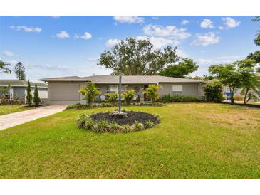 Charming single-story home featuring a well-manicured lawn with landscaped accents at 5245 18Th N St, St Petersburg, FL 33714