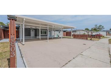 Well-maintained single-story home with a spacious carport and manicured lawn at 5803 Cresthill Dr, Tampa, FL 33615