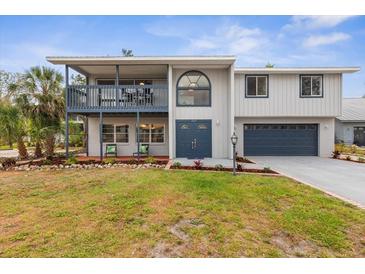 Charming two-story home boasting a well-manicured lawn, upper porch, and an attached two car garage at 824 35Th Avenue W Dr, Palmetto, FL 34221