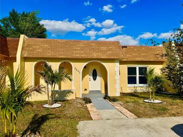 Charming single-story home with a well-maintained front yard and beautiful blue skies at 9893 86Th N Way, Seminole, FL 33777