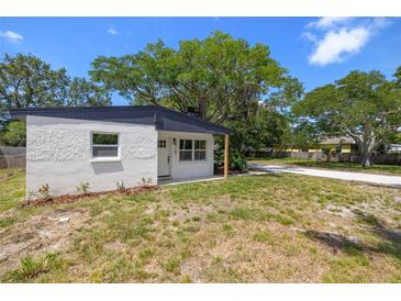 Charming single-story home featuring a textured exterior, a dark roof, and a well-maintained front lawn at 2157 20Th Sw Ave, Largo, FL 33774