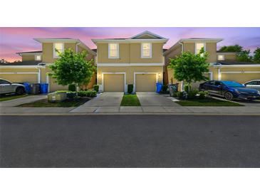 Two-story townhomes featuring attached garages, manicured lawns, and inviting curb appeal at 2234 Lennox Dale Ln, Brandon, FL 33510