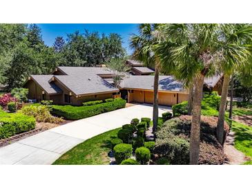 Stunning single-story home featuring mature landscaping, long driveway, and attached two car garage at 29903 Baywood Ln, Wesley Chapel, FL 33543