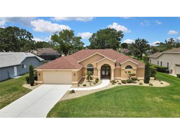 Beautiful single-story home featuring lush landscaping and a welcoming entrance at 9346 Southern Belle Dr, Weeki Wachee, FL 34613