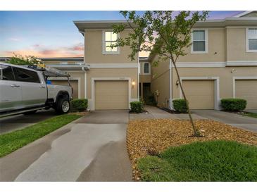 Inviting townhome featuring a one car garage, neutral paint and well maintained landscaping at 2129 Lennox Dale Ln, Brandon, FL 33510