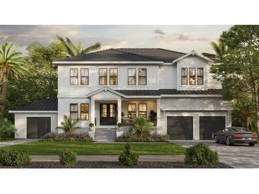Stunning two-story white home with a charming front porch, lush landscaping, and an attached two-car garage at 690 Geneva Pl, Tampa, FL 33606