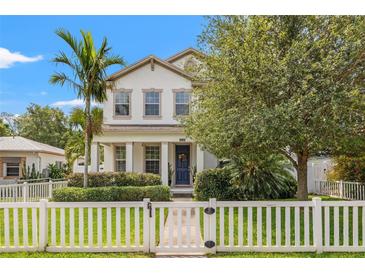 Charming two-story home featuring a white picket fence, manicured landscaping, and a welcoming front entrance at 1436 30Th N Ave, St Petersburg, FL 33704