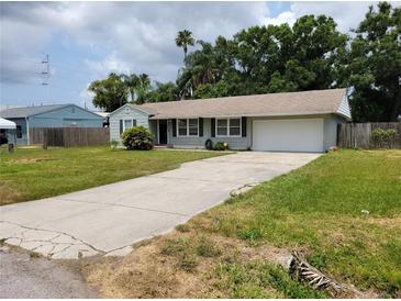 Charming single-story home featuring a well-manicured lawn and a private two-car garage at 2701 47Th N Ave, St Petersburg, FL 33714
