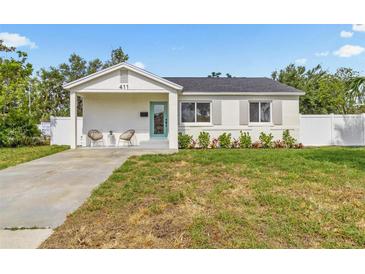 Charming single-story home with a well-maintained lawn and a cozy front porch area at 411 37Th S St, St Petersburg, FL 33711