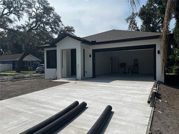 A contemporary home with a spacious two-car garage and newly paved driveway at 4241 E Palifox St, Tampa, FL 33610