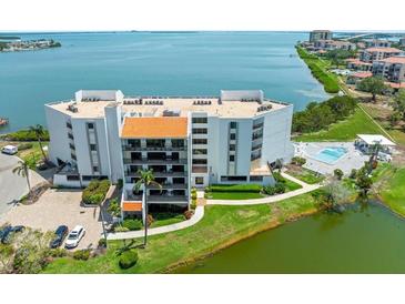 Stunning aerial view of the building with beautiful waterfront views and a refreshing pool at 5700 Escondida S Blvd # 401, St Petersburg, FL 33715