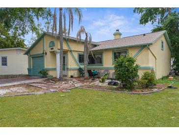 Charming single Gathering home featuring a front yard, garden, and pleasant curb appeal at 6028 Central Ave, New Port Richey, FL 34653