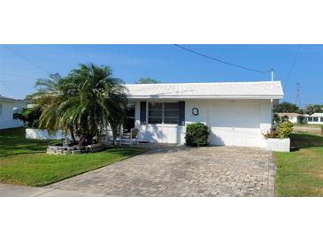 Charming single-story home featuring a brick driveway, attached garage, and well-maintained landscaping at 10040 38Th N Way, Pinellas Park, FL 33782