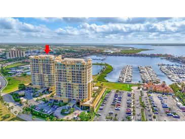 Stunning aerial view of luxury high-rise condos with marina and waterfront views at 140 Riviera Dunes Way # 1203, Palmetto, FL 34221