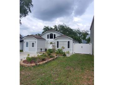 Charming single-Gathering home featuring a landscaped front yard and inviting curb appeal at 8207 Volusia Pl, Tampa, FL 33637