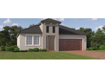 Charming single Gathering home with neutral stucco, dark roof, manicured lawn, and two car garage at 9711 Minnow Ray Dr, Land O Lakes, FL 34638