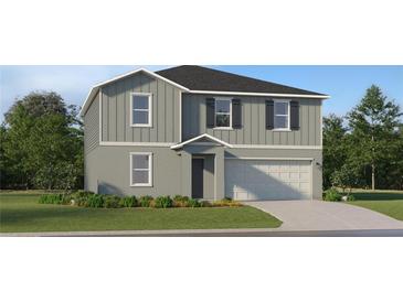 Charming two-story home with attached garage, landscaping, and neutral-colored exterior at 12025 Brae Way, Dade City, FL 33525