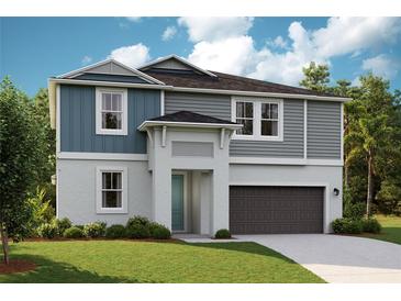 Charming two-story home with a gray color scheme, landscaped yard, and attached two-car garage at 12172 Cattleside Dr, Riverview, FL 33579