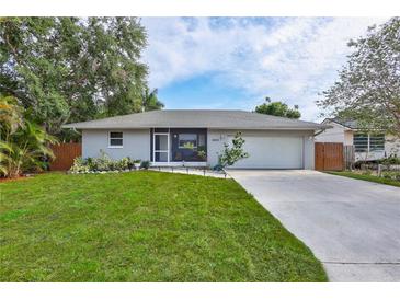 Charming single-story home with well-maintained lawn, lovely landscaping, and an attached two-car garage at 2620 49Th N Ave, St Petersburg, FL 33714