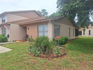Charming townhouse featuring well-maintained landscaping and inviting curb appeal at 3835 Sailmaker Ln # X, Holiday, FL 34691