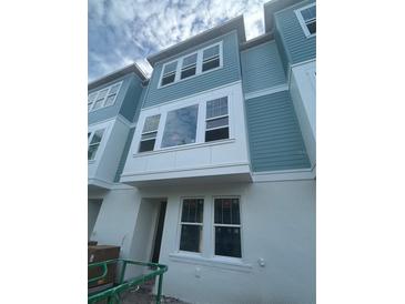 New construction townhome showcases a light blue exterior, white trim, and energy-efficient windows at 479 31St N Way, St Petersburg, FL 33713