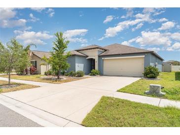 Charming single Gathering home with a well-manicured lawn and a two-car garage at 7305 Tiger Trail Ct, Sun City Center, FL 33573