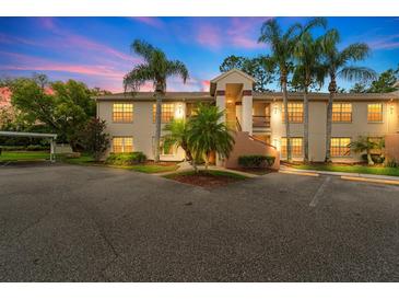 Inviting two-story condo with lush landscaping and ample parking at dusk at 7910 Hardwick Dr # 717, New Port Richey, FL 34653