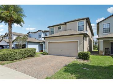 Charming two-story home with a brick paver driveway and manicured landscaping in a well-maintained community at 1119 Ballard Green Pl, Brandon, FL 33511
