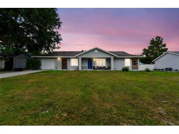 Charming single-story home with a well-manicured lawn, beautiful front door, and inviting curb appeal at 12106 Meadow Ln, San Antonio, FL 33576