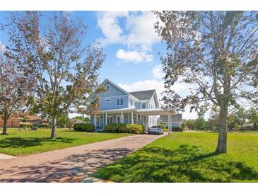 Charming two-story home featuring a brick driveway and a covered carport at 2009 153Rd E Ct, Bradenton, FL 34212
