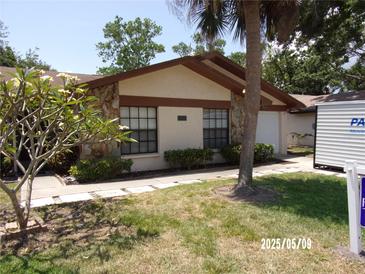 Charming single-story home with stone accents, mature landscaping, and a well-maintained lawn at 2025 Dover Ct, Oldsmar, FL 34677