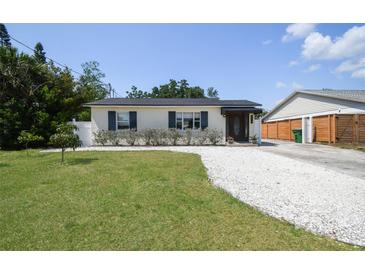 Charming single-story home featuring a well-manicured lawn and a welcoming front entrance at 3315 W Pearl Ave, Tampa, FL 33611