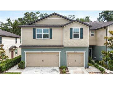 Charming two-story townhome featuring dual garages and well-maintained landscaping at 5344 Sylvester Loop, Tampa, FL 33610