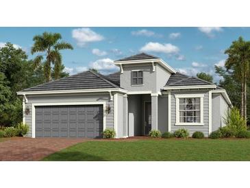 Charming single-Gathering home featuring a two-car garage, neutral paint, landscaped lawn, and well-maintained exterior at 12902 Tulum Loop, Venice, FL 34293