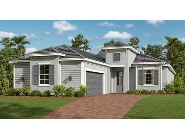 Charming single-story home with gray siding, black shutters, attached garage and well manicured lawn at 12950 Tulum Loop, Venice, FL 34293