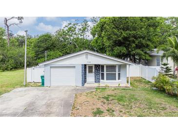 Charming single-story home featuring a well-manicured lawn and an attached one-car garage at 15100 Avalon Ave, Clearwater, FL 33760
