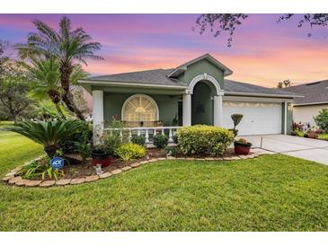 Charming single-Gathering home with a well-manicured lawn, columns and garden at 1932 Sean Wood Cir, Brandon, FL 33510