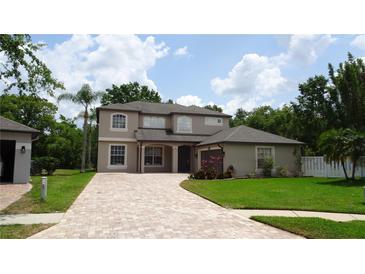 Beautiful two-story home with a brick paved driveway and lush landscaping at 3914 Roswell Pl, Land O Lakes, FL 34639