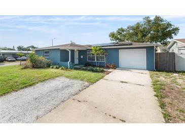 Inviting exterior of a blue home with a concrete driveway and manicured front yard at 4238 Glissade Dr, New Port Richey, FL 34652