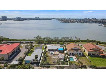 Waterfront home lot outlined in white with skyline in background at 7075 Sunset S Dr, South Pasadena, FL 33707