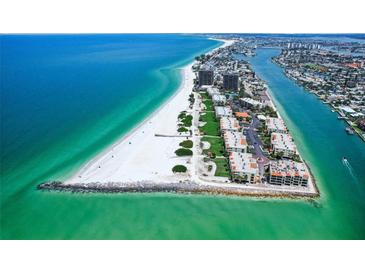 Stunning aerial view of beachfront condos with turquoise waters and white sand beach at 7564 Bayshore Dr # 302, Treasure Island, FL 33706