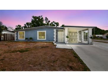 Charming single-story home with a unique gated entrance and cozy front yard at 8006 Tanglewood Ln, Tampa, FL 33615