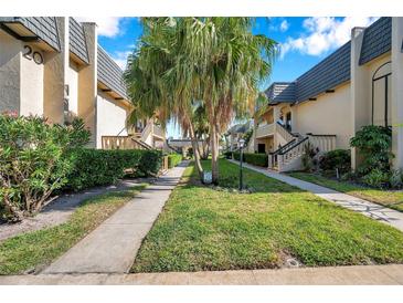 Inviting condominium community with manicured lawns and well-maintained sidewalks at 2003 Cordova Grn, Seminole, FL 33777